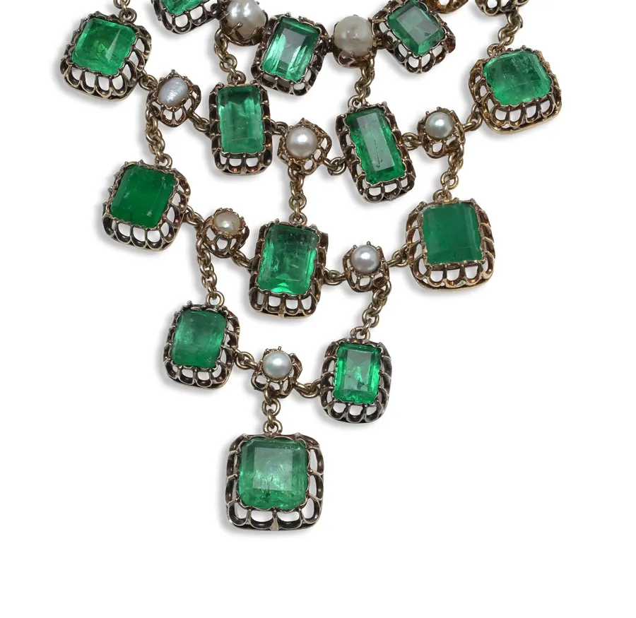 Detail of a Georgian emerald and natural pearl necklace with emeralds in individual collets