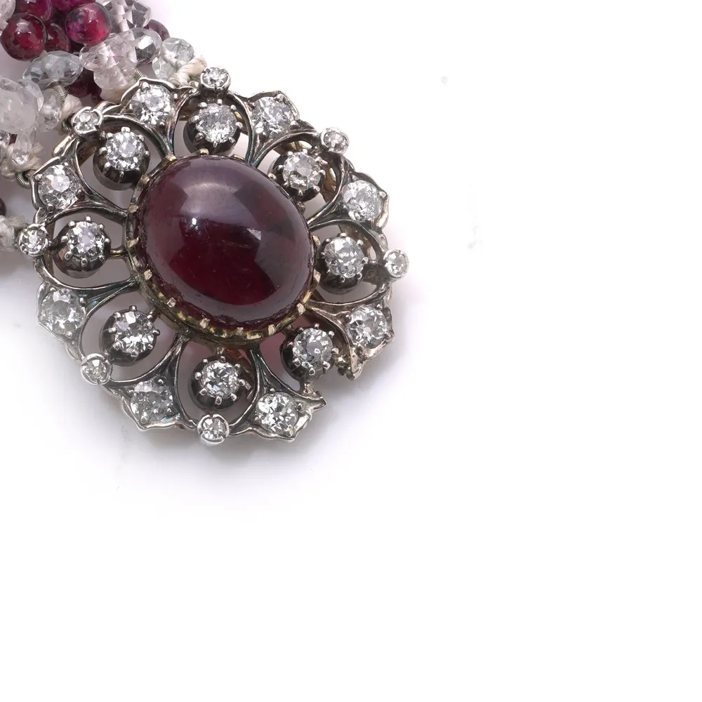 Gem-set clasp with a cabochon garnet in a cluster of old cut diamonds, on a Victorian garnet and quartz bead bracelet
