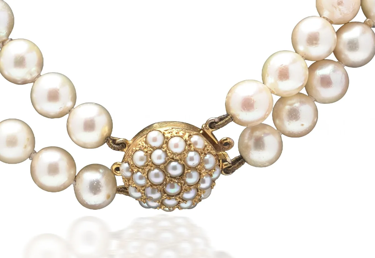Round 9KT gold box clasp set with seed pearls on a double strand cultured pearl necklace, circa 1960s