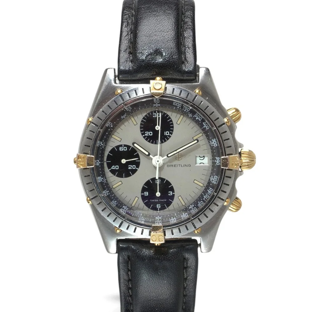 A Breitling Chronomat B13047 in steel and gold with a grey dial, three black registers and gold rider tabs on the bezel