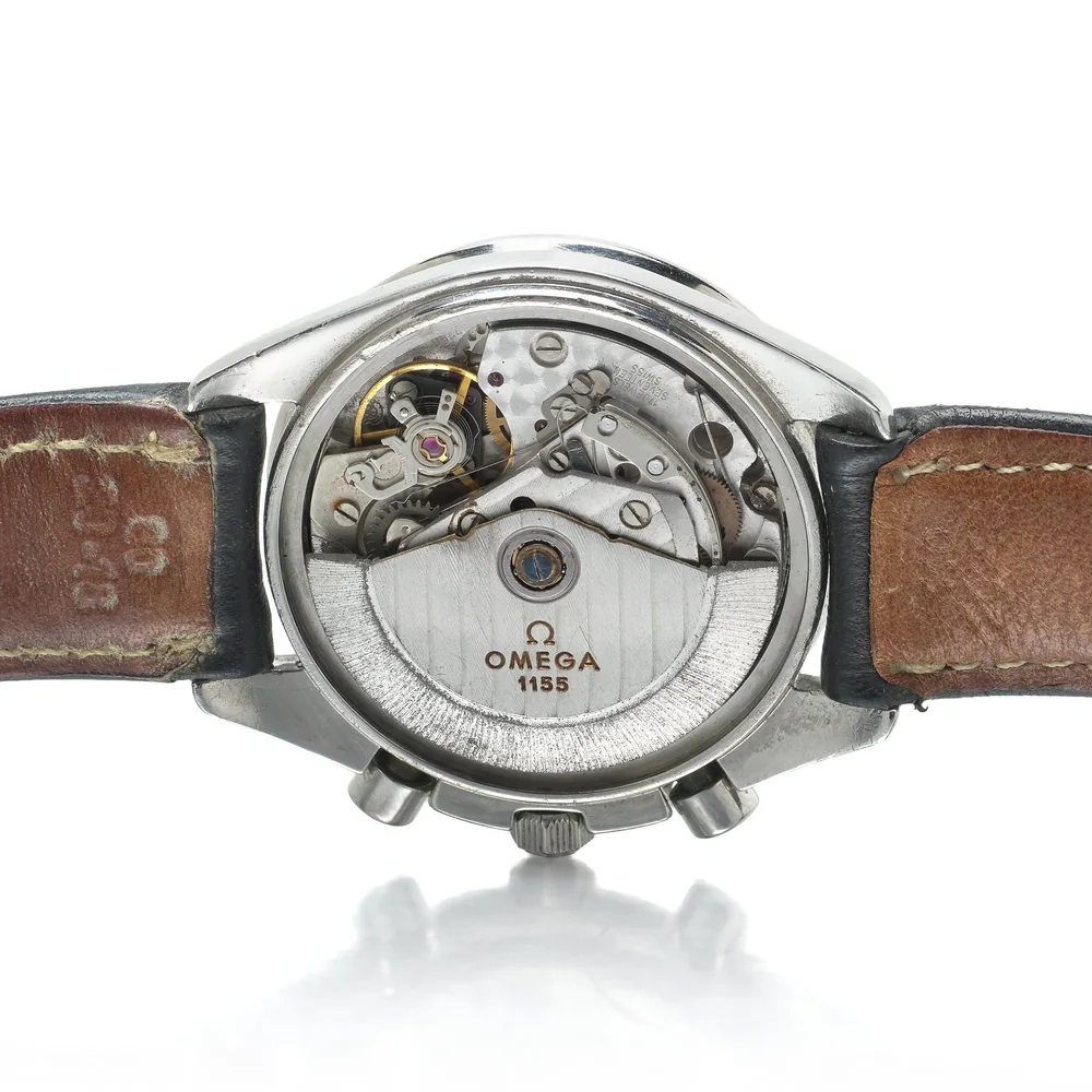 The open back of an Omega Speedmaster Date showing the automatic calibre 1155 chronograph movement and its rotor
