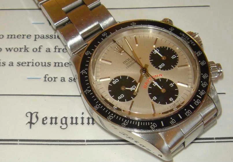 A steel Rolex Daytona ref. 6263 with a silver dial, three black sub-dials, red Daytona lettering and a black tachymeter bezel