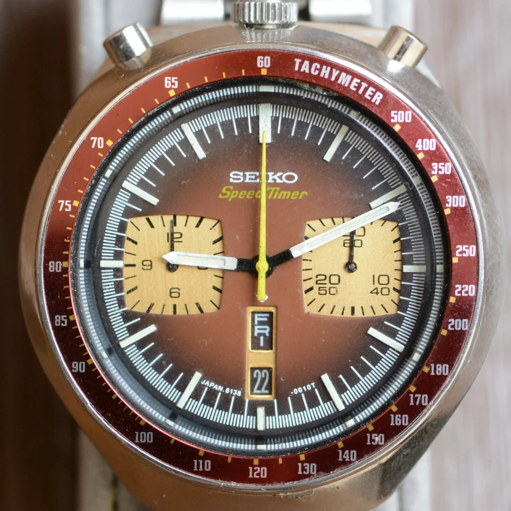 A 1976 Seiko Speed-Timer 6138-0040 Bullhead chronograph with its crown and two pushers on top of the case and a brown dial