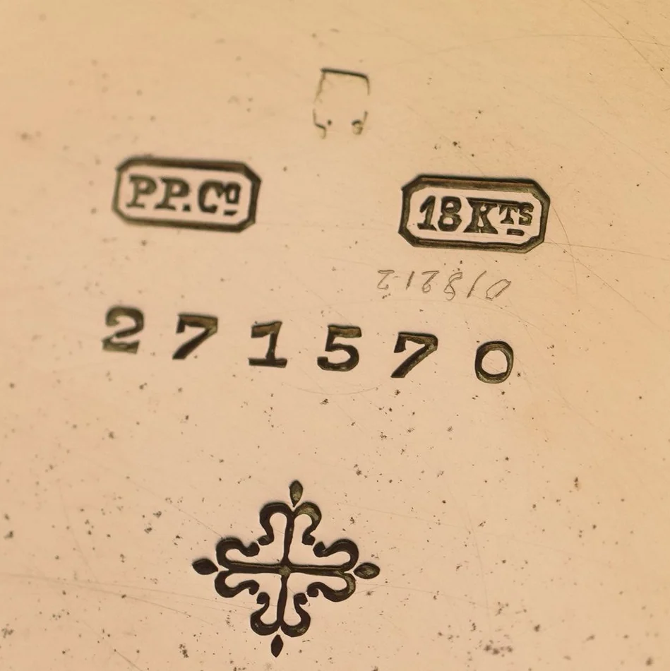 Inside the back of a Patek Philippe gold pocket watch: PP.Co mark, 18Kts, case number 271570 and the Calatrava cross