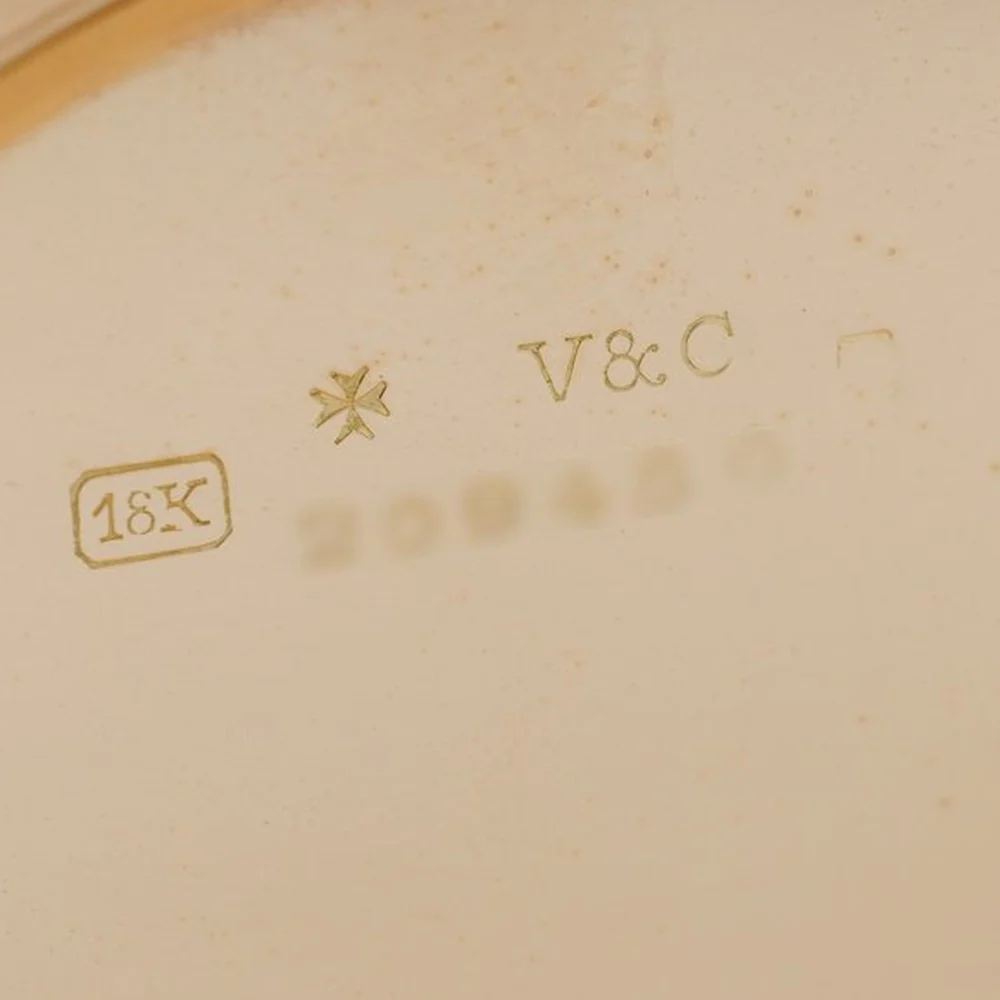 Inside a Vacheron and Constantin gold pocket watch case: 18K stamp, Maltese cross and V&C