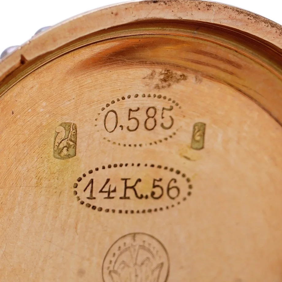 Swiss squirrel hallmarks beside the 0,585 fineness mark inside a 14ct rose gold watch case