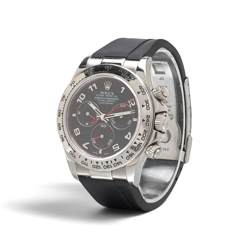 Rolex Daytona 116519 in white gold seen at an angle, showing the engraved tachymeter bezel, crown and screw-down pushers