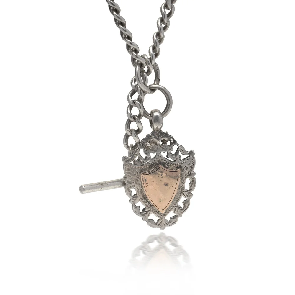 An antique silver Albert chain with a T-bar and a shield fob with a 9ct gold face, c.1910s to 1920s