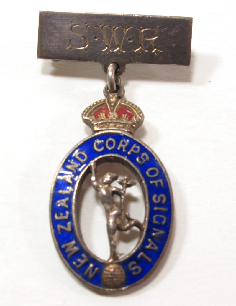 A Second World War silver and enamel sweetheart brooch: a Corps of Signals badge with the figure of Mercury hanging from a bar engraved with initials