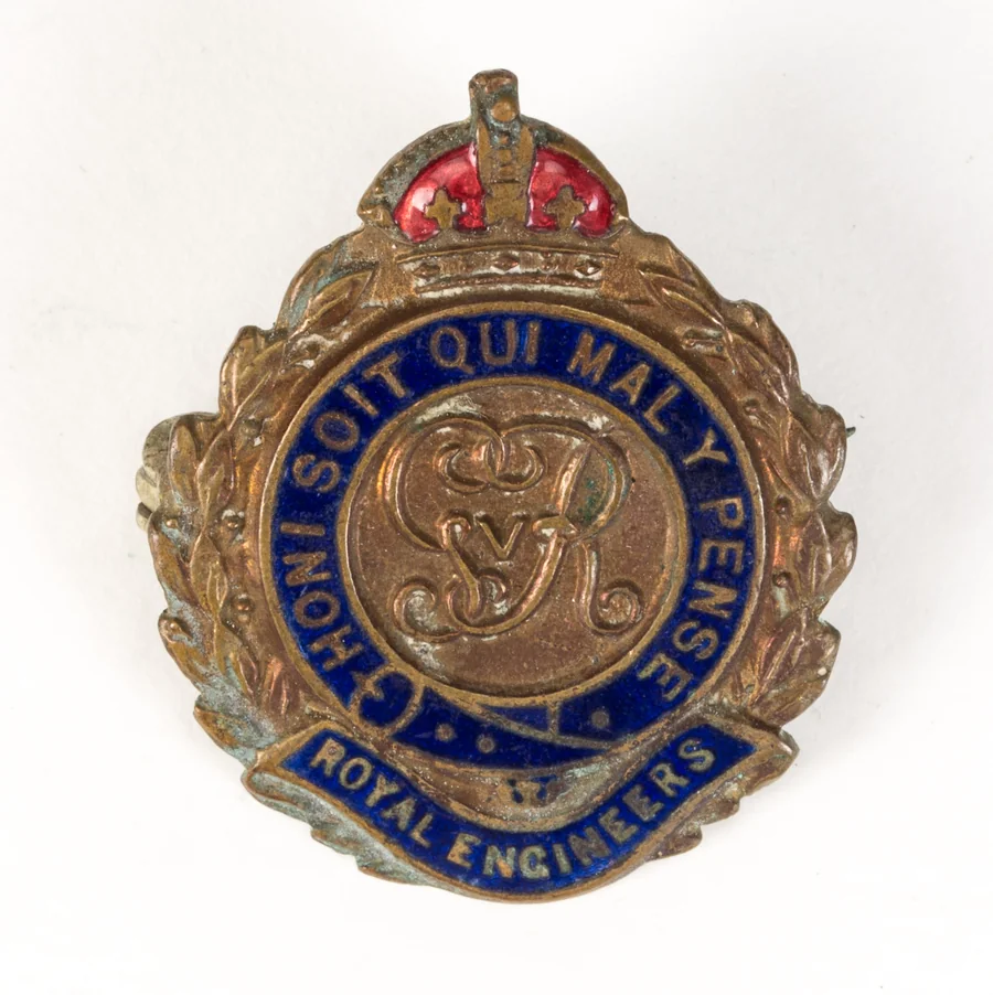 A Royal Engineers sweetheart brooch: a royal cypher inside a blue enamel Garter reading HONI SOIT QUI MAL Y PENSE, a crown above and a ROYAL ENGINEERS scroll below