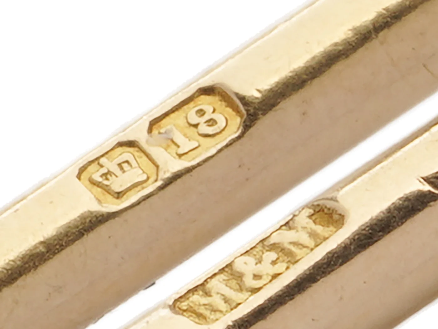 Hallmark on a Victorian 18 carat gold Albert chain: a crown beside the number 18 and the sponsor's mark M&M, struck on a gold bar