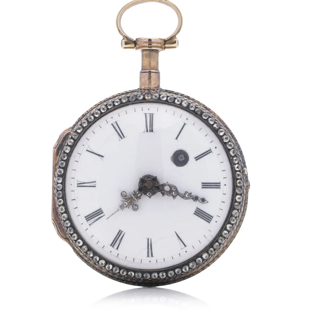 18th century verge pocket watch with a paste set bezel and white enamel dial wound through a hole at two o'clock