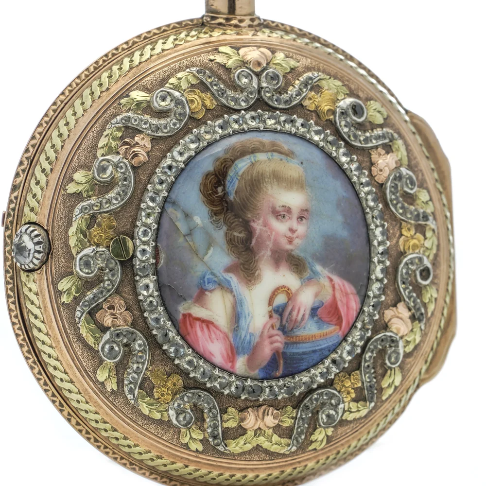 Back of an 18th century verge pocket watch case with a painted enamel portrait of a young woman framed in paste and coloured gold