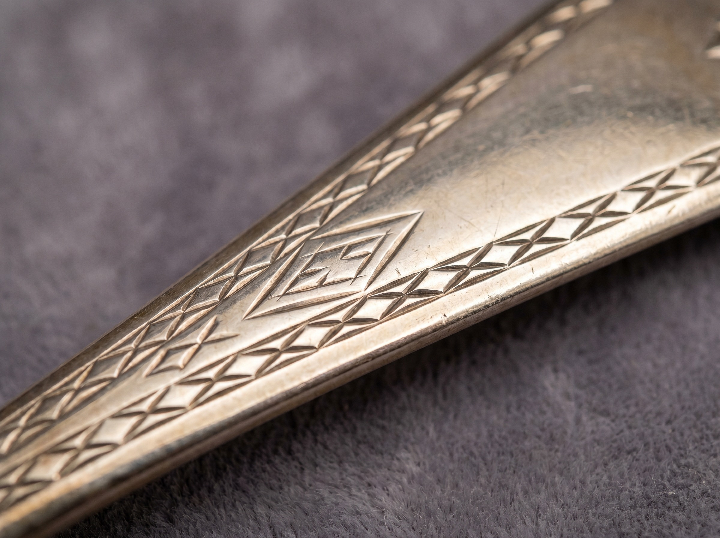 Bright-cut engraving on Hester Bateman Georgian sterling silver — extreme macro