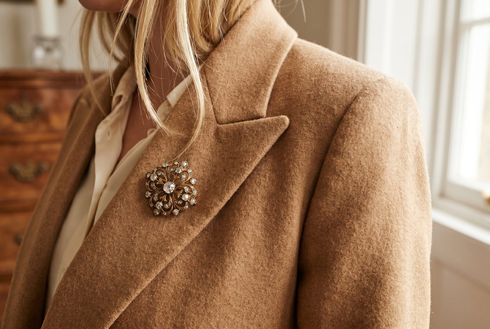 How to wear an antique brooch — an antique diamond and gold brooch styled high on a blazer lapel