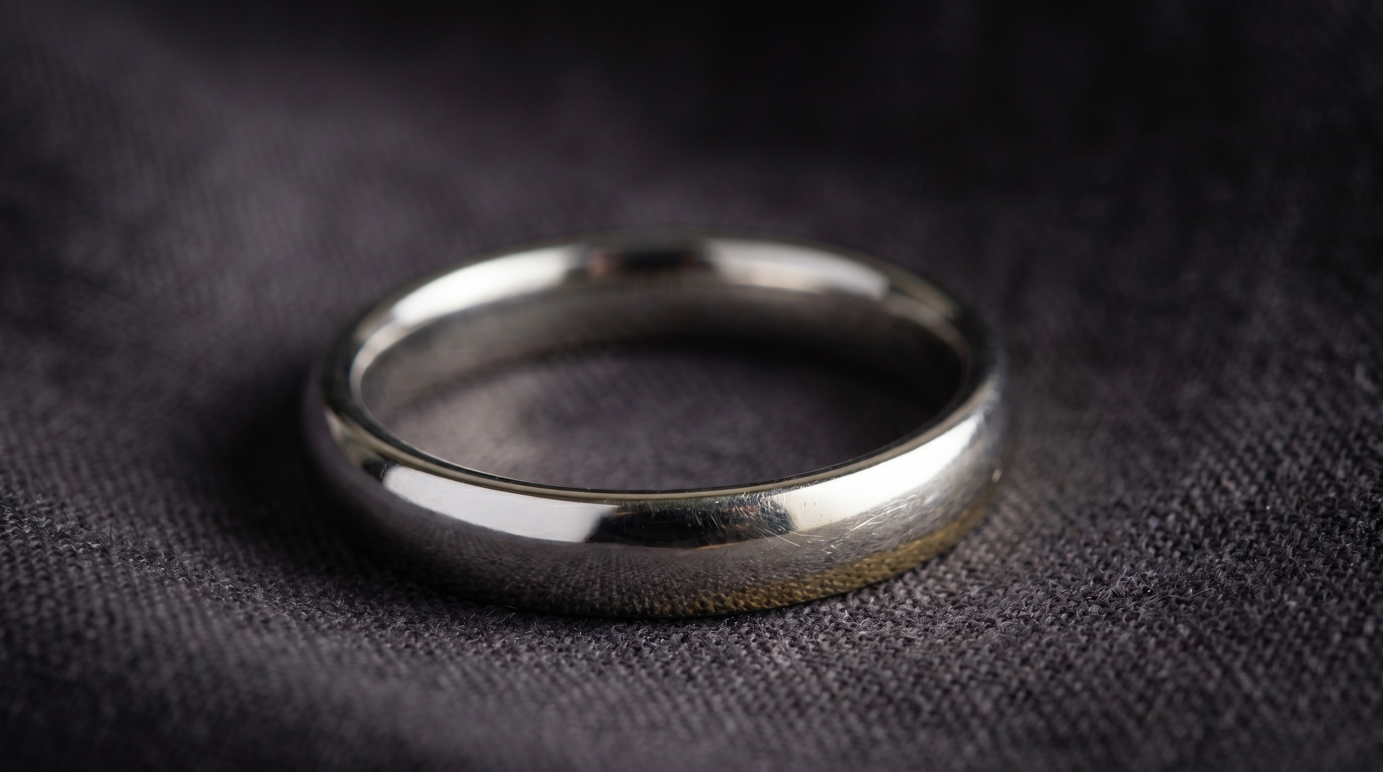 White gold ring showing a faint yellow tinge where rhodium plating has worn thin