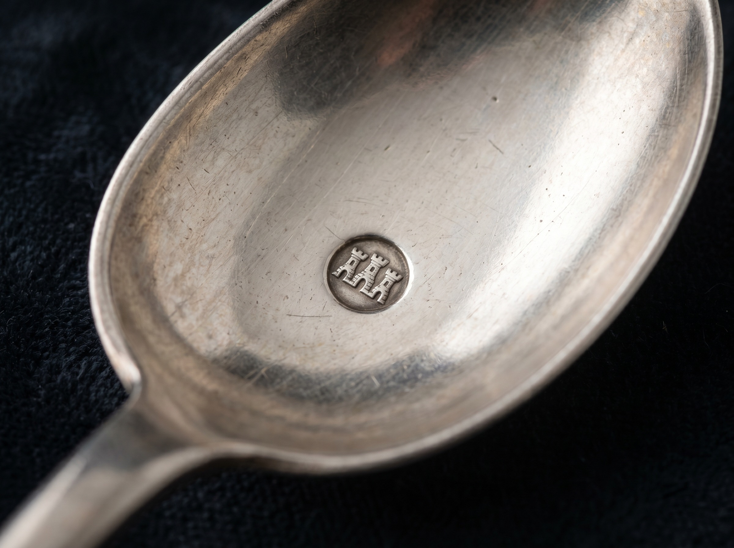 Extreme macro of Newcastle Assay Office three castles hallmark struck on antique sterling silver