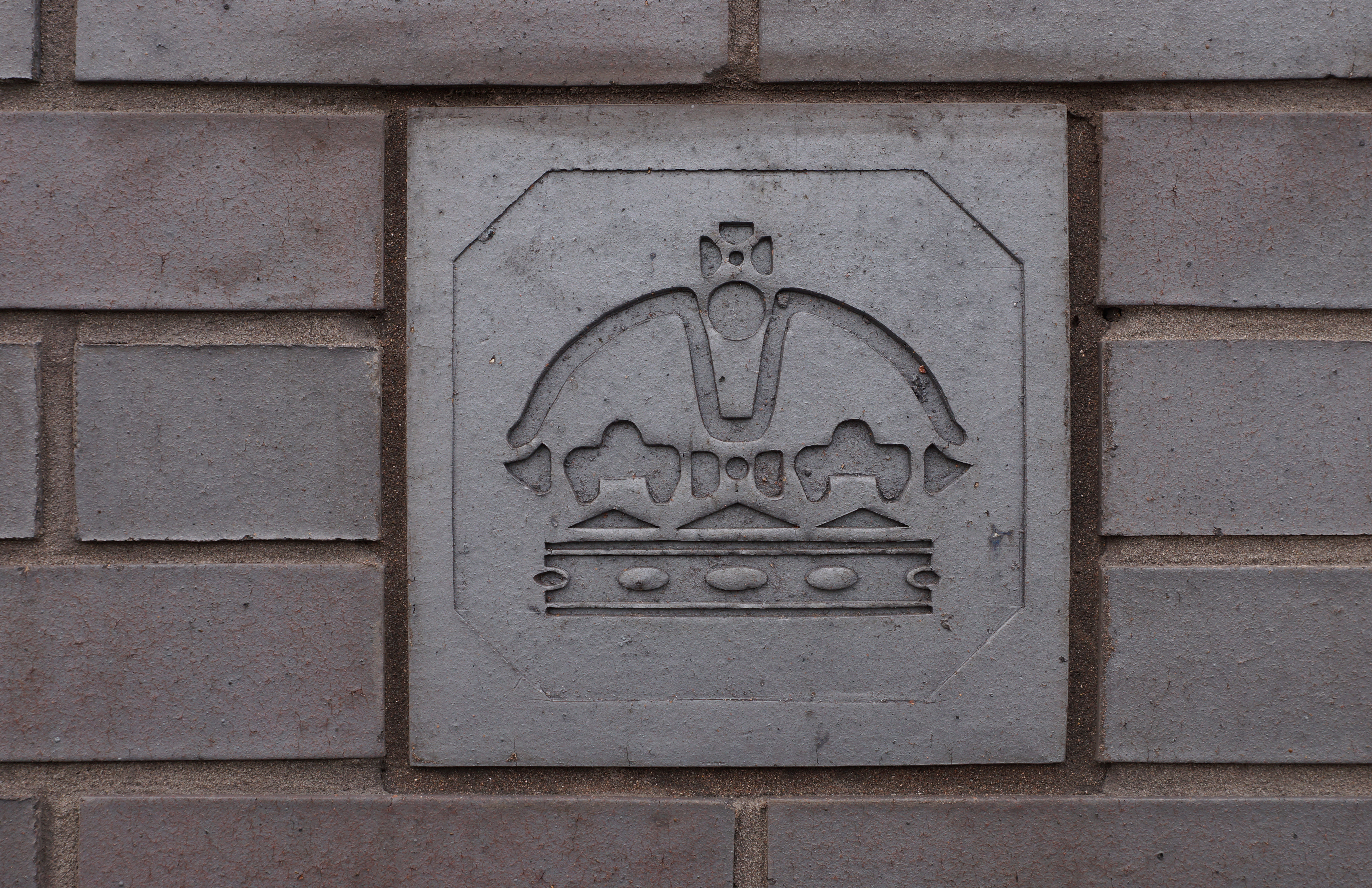 The crown gold hallmark, set in brick on the wall of the Birmingham Assay Office, which compiles the UK hallmarking figures