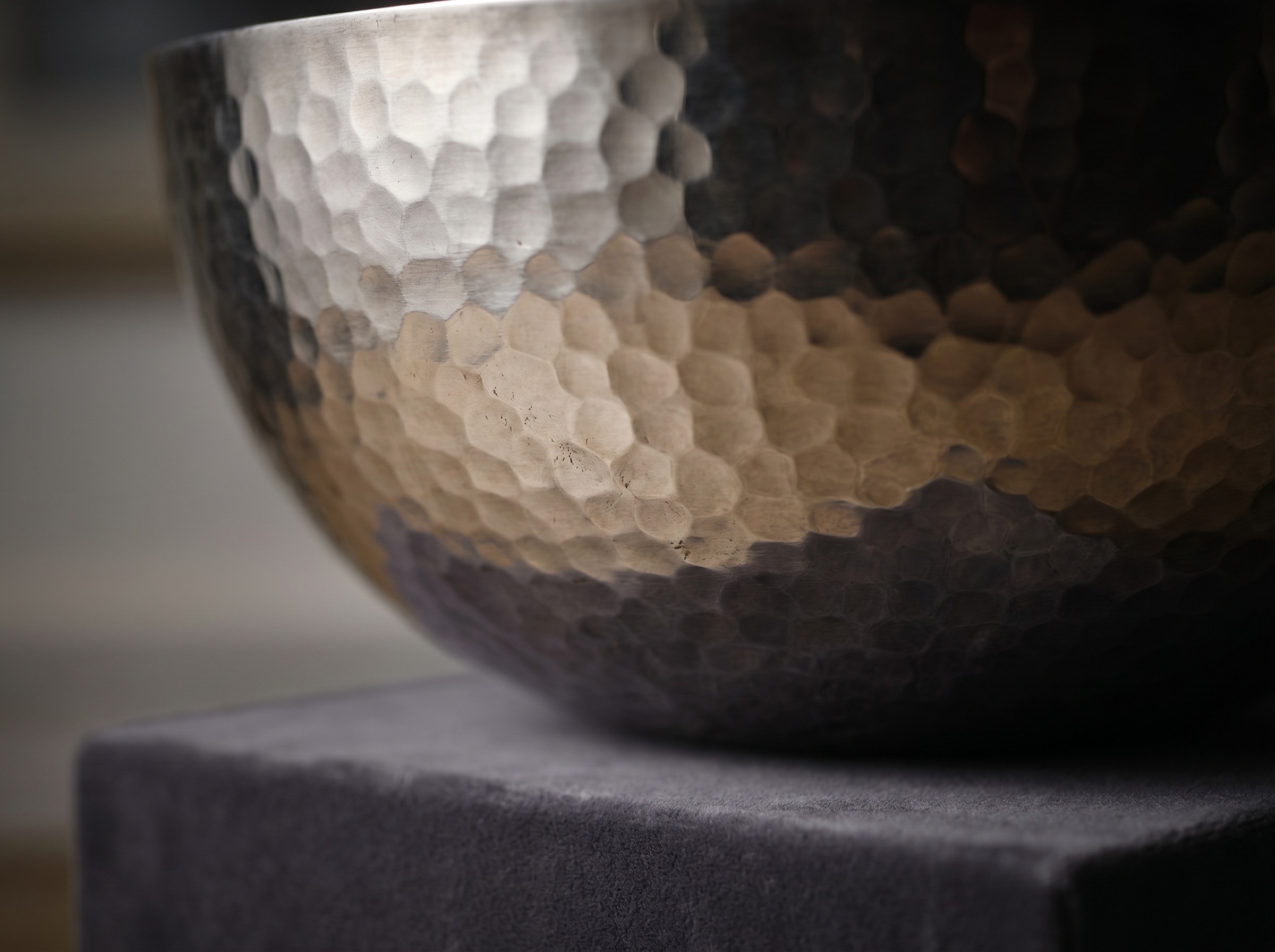 Hammered planished surface of an Omar Ramsden Arts and Crafts silver piece — extreme macro