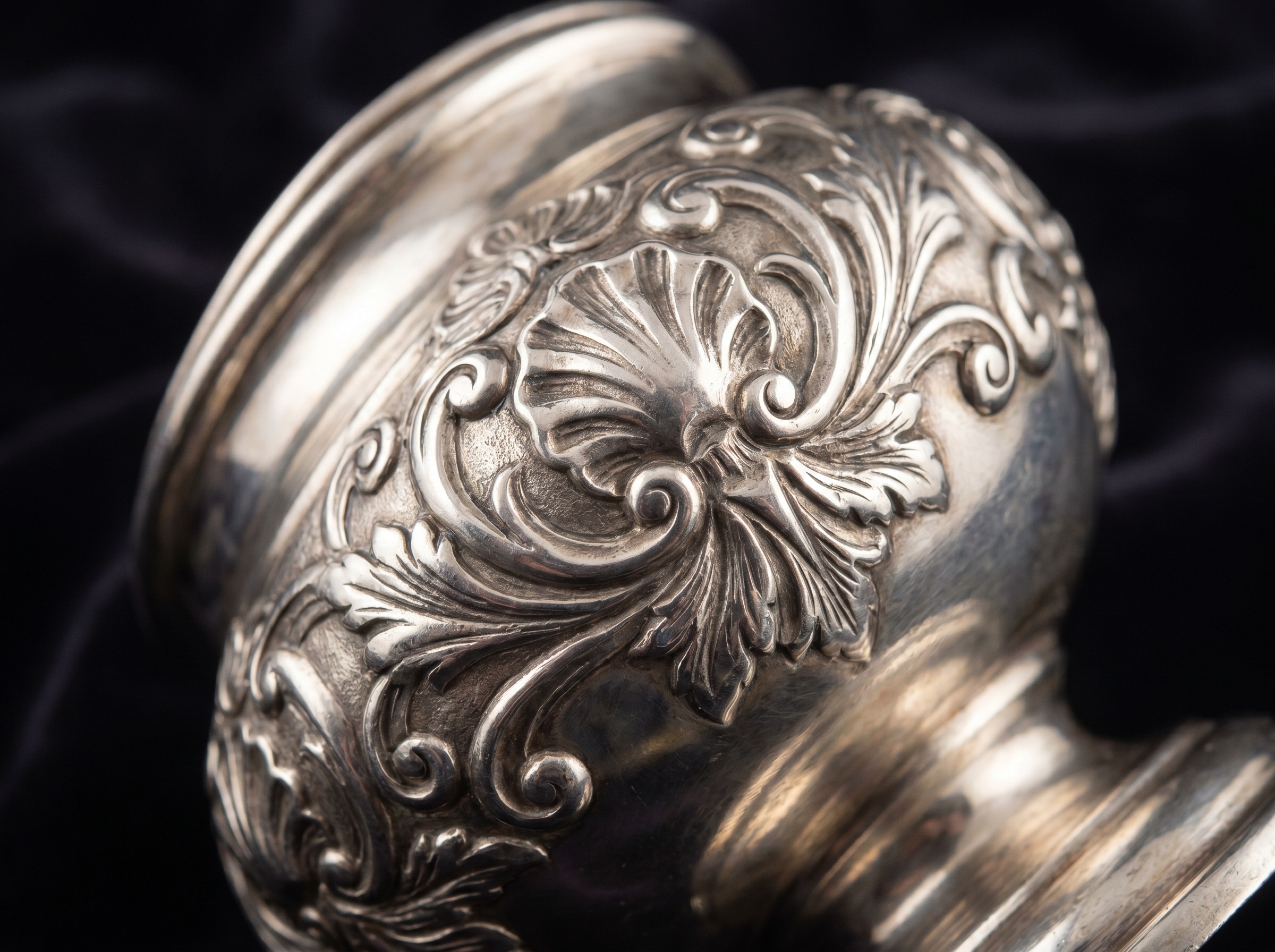 Extreme macro of applied cast Rococo ornament on antique English sterling silver — shells, scrolls and foliage