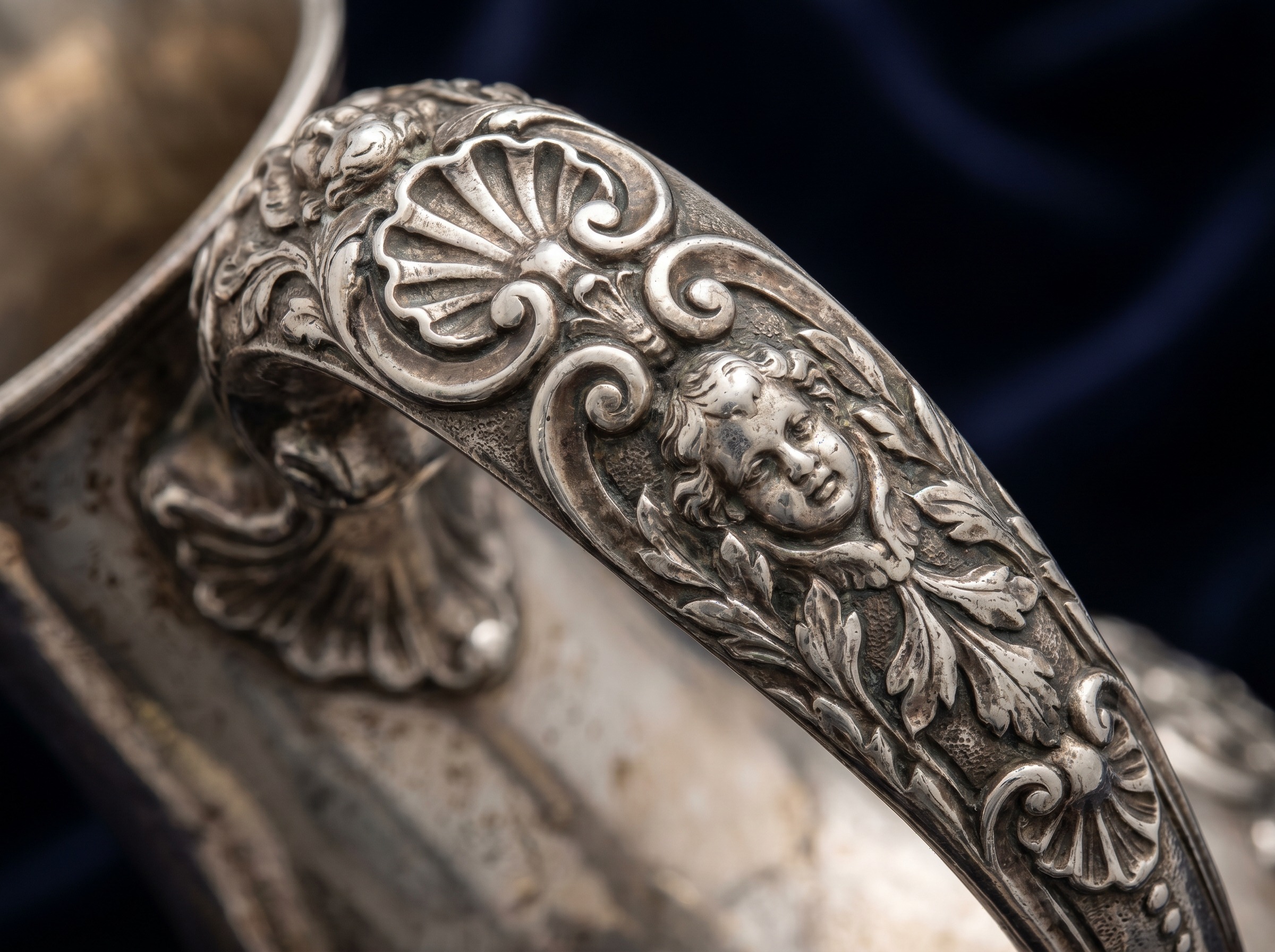 Cast and chased rococo decoration in the manner of Paul de Lamerie — extreme macro