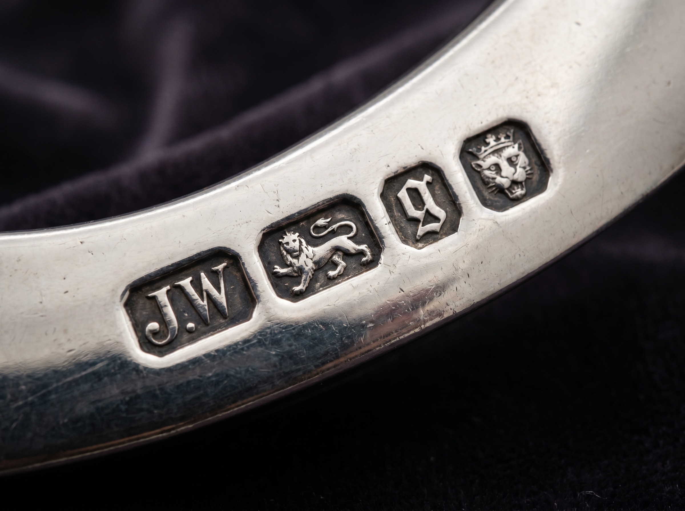Extreme macro of London silver hallmarks on late Georgian sterling silver — maker's mark, leopard's head, lion passant, date letter, sovereign's head