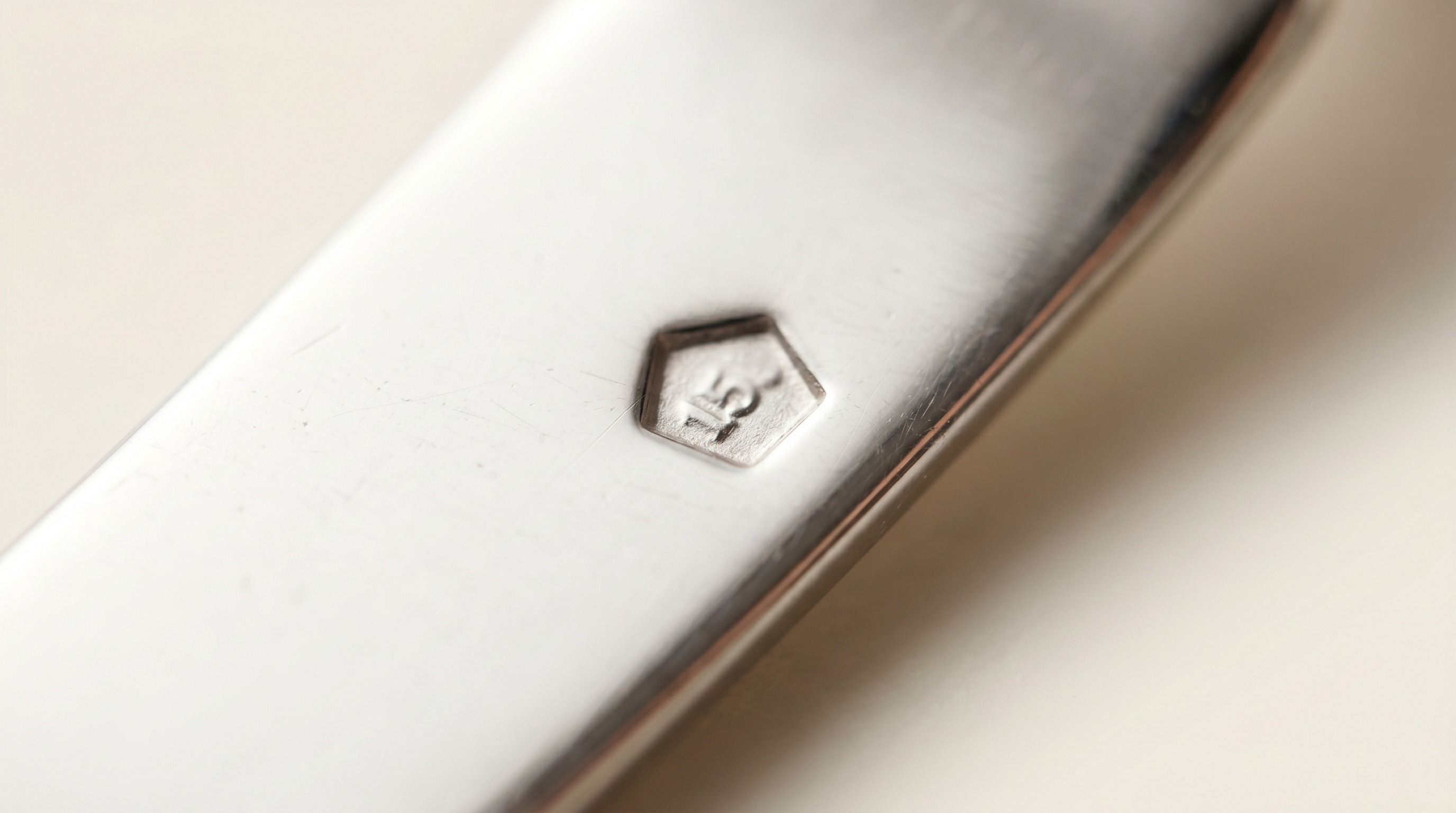 Five-sided pentagon platinum fineness hallmark on a bright white platinum band