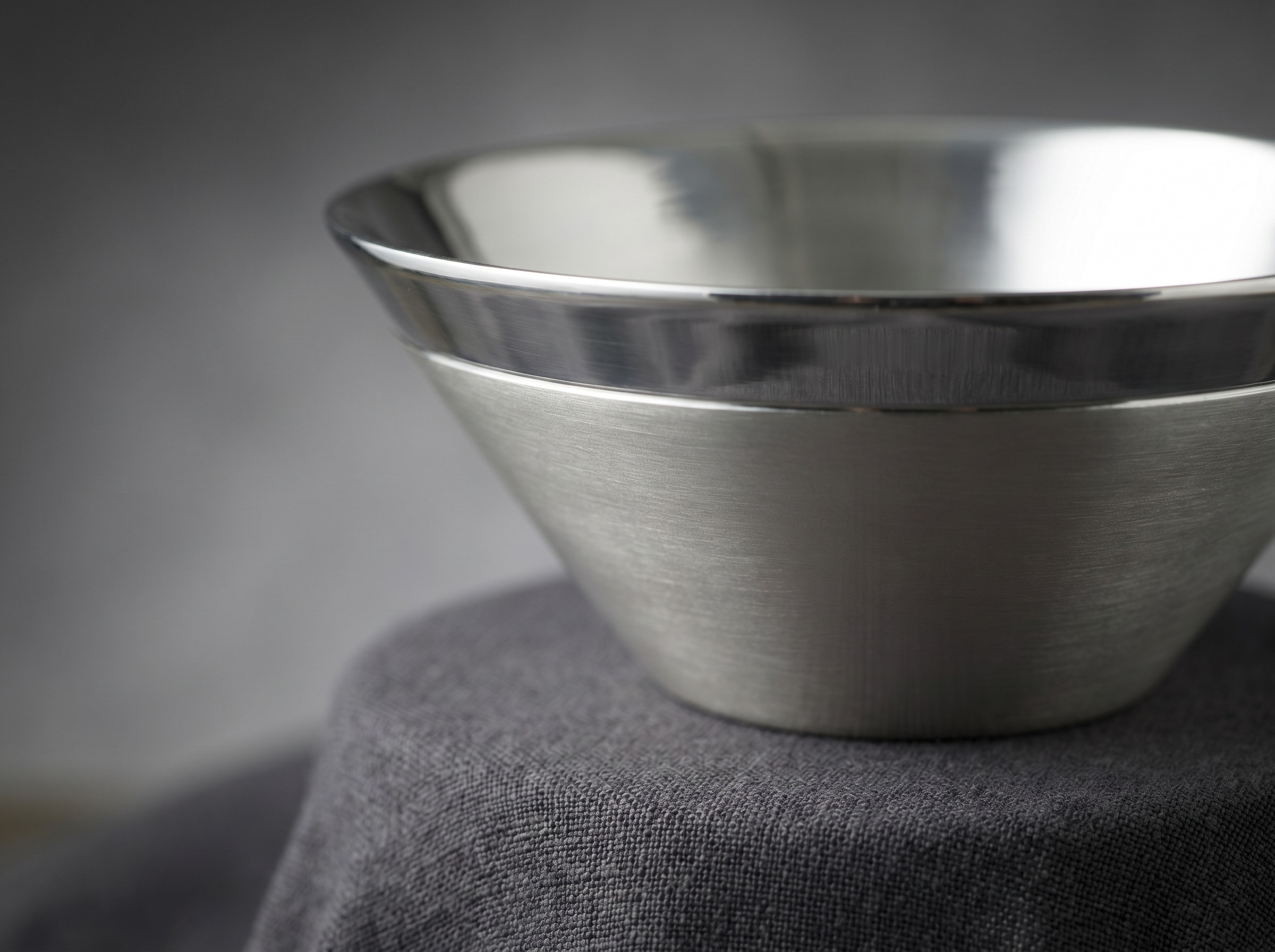 Smooth sculptural mid-century modern sterling silver vessel in the Robert Welch style — macro