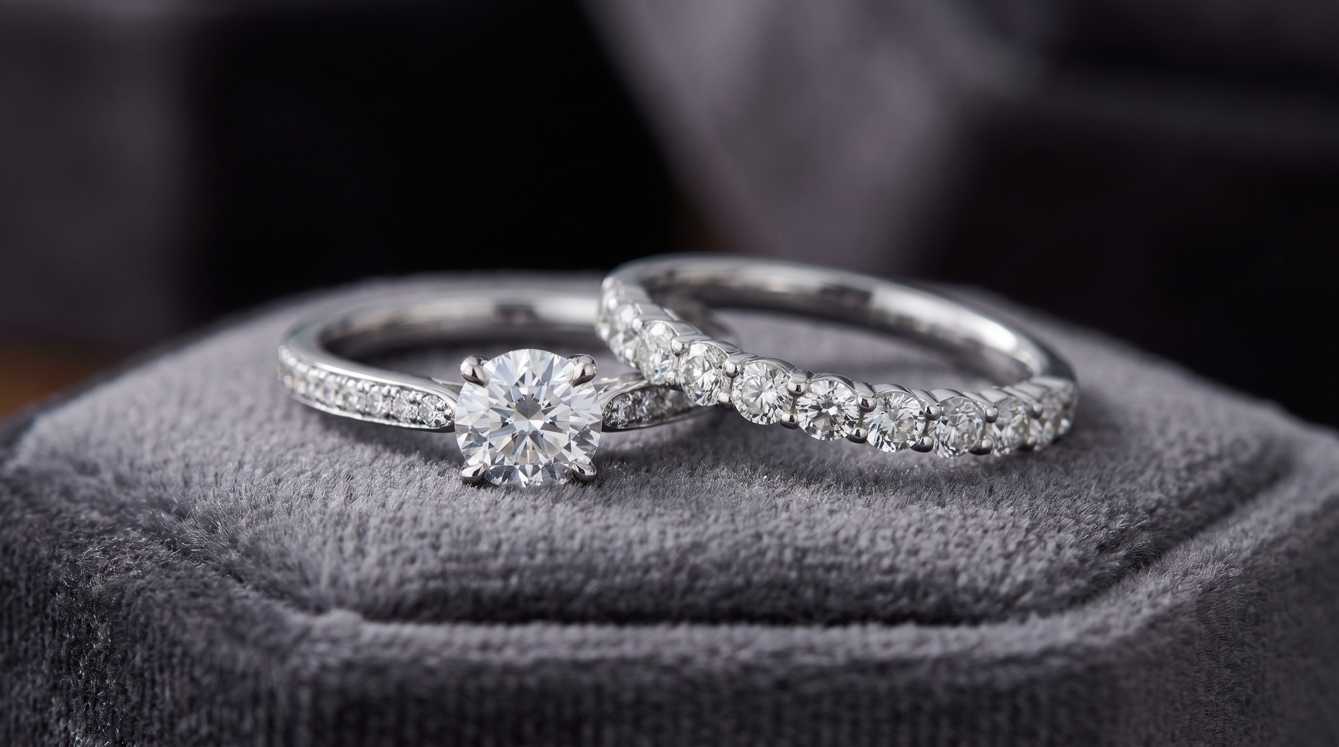 Platinum diamond engagement rings and a wedding band in bright white metal