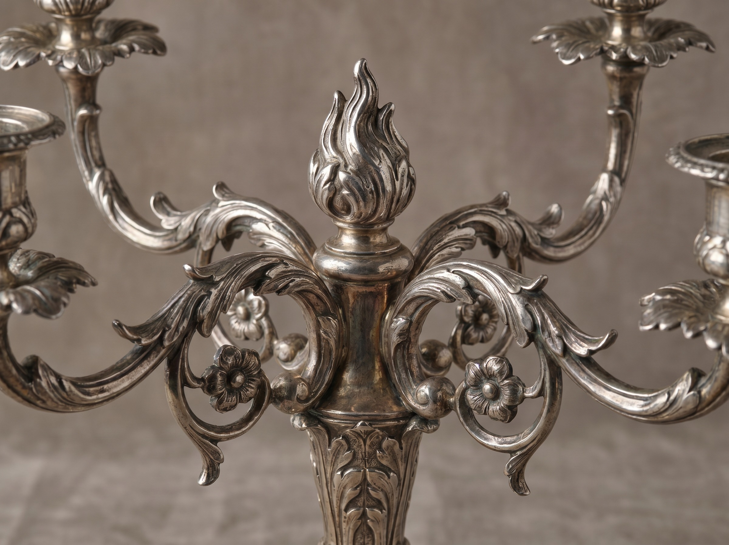 Cast scrolling foliate branches of an antique English sterling silver candelabrum