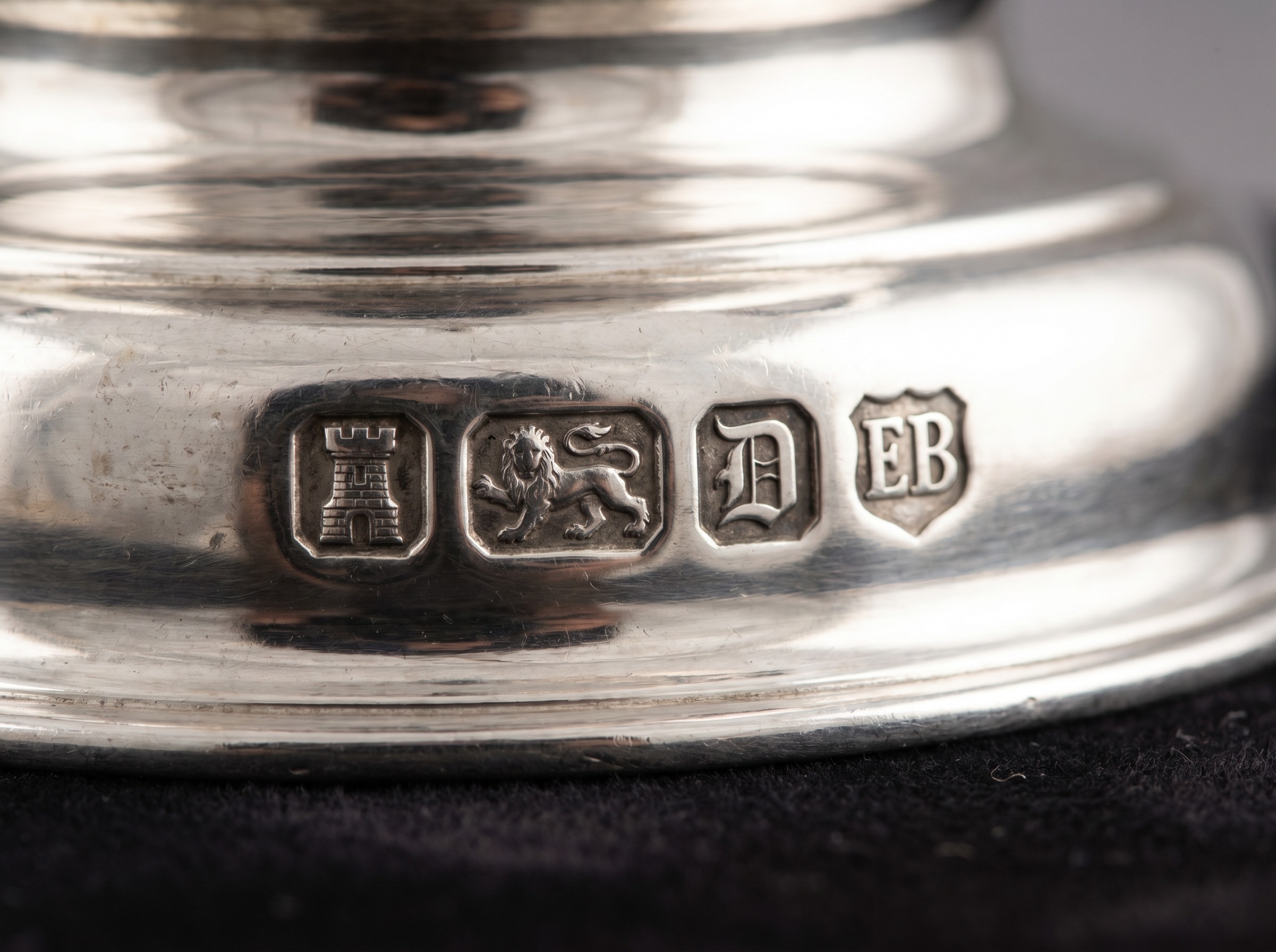 British silver hallmarks on the base of an antique sterling silver coffee pot — extreme macro