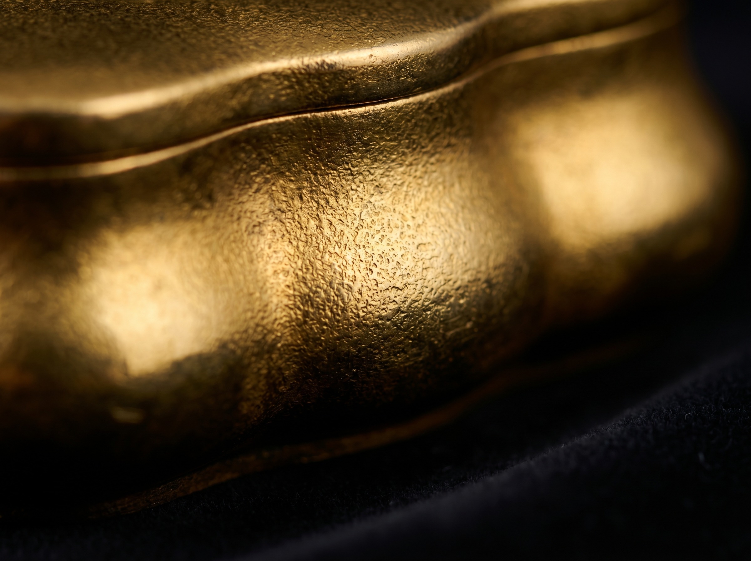 Fire-gilded silver surface — extreme macro showing rich warm gold