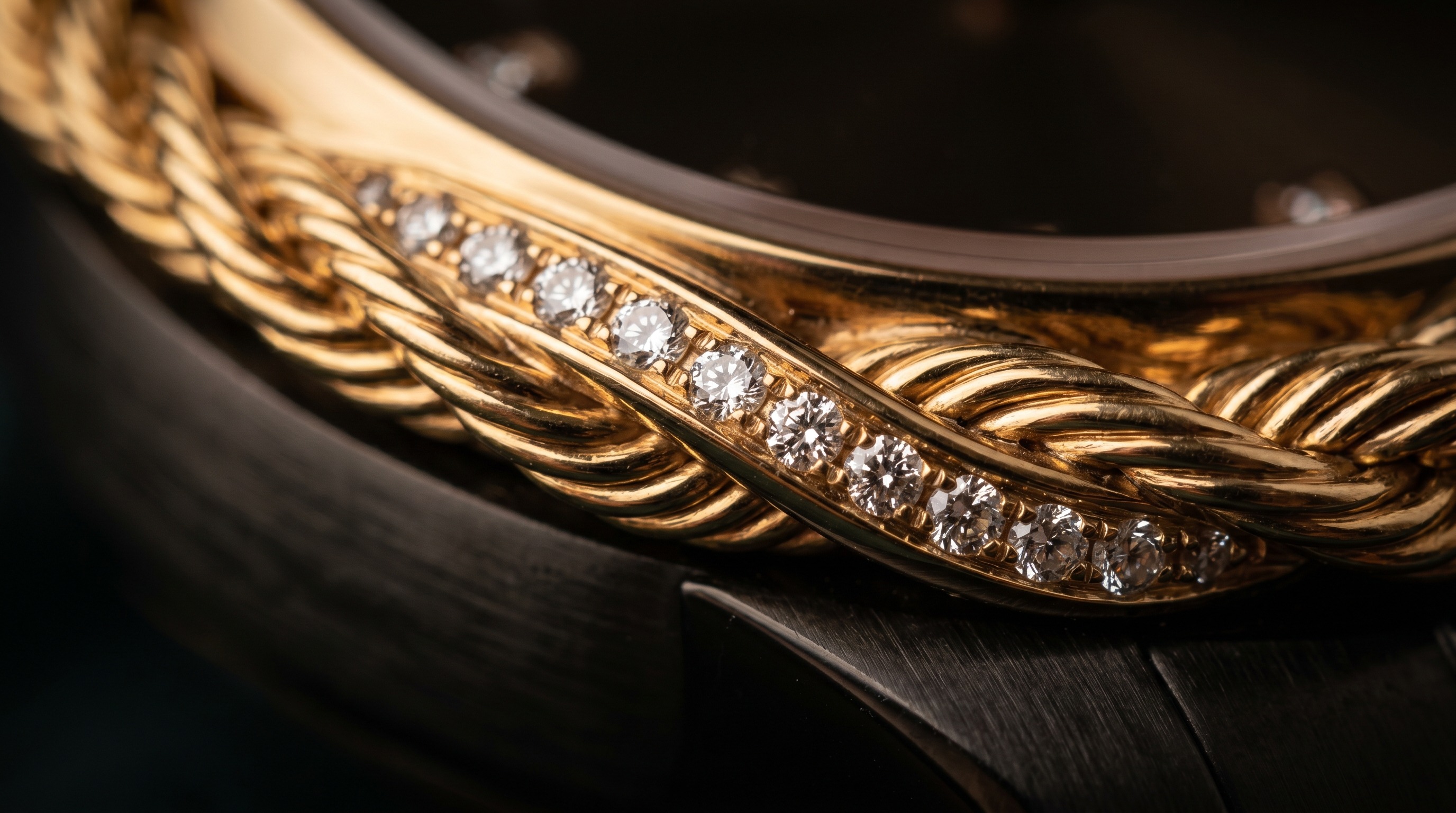 Close-up of a twisted gold rope motif with pavé diamonds