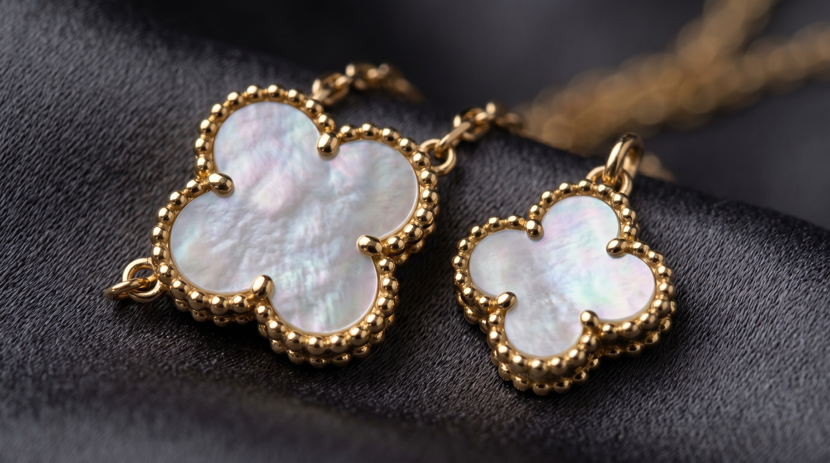 Close-up of two differently sized Van Cleef Magic Alhambra clover motifs